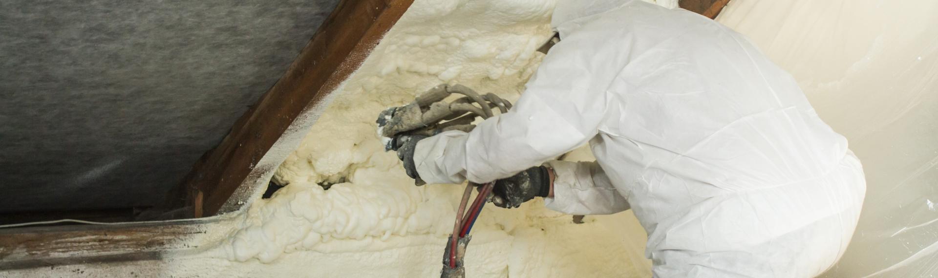 Technician Applying Spray Foam Insulation to Attic